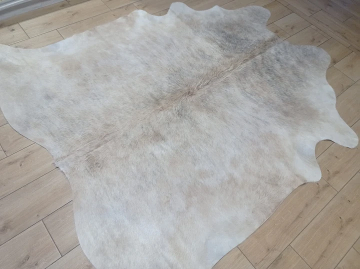 Naturalna skóra bydlęca 200x195 cm rozłożona w dużym salonie  - dekoracyjneskory.pl