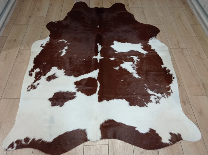 Naturalna skóra bydlęca 195x155 cm rozłożona w dużym salonie  - dekoracyjneskory.pl