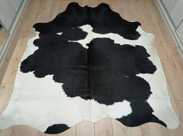 Naturalna skóra bydlęca 225x195 cm rozłożona w dużym salonie  - dekoracyjneskory.pl